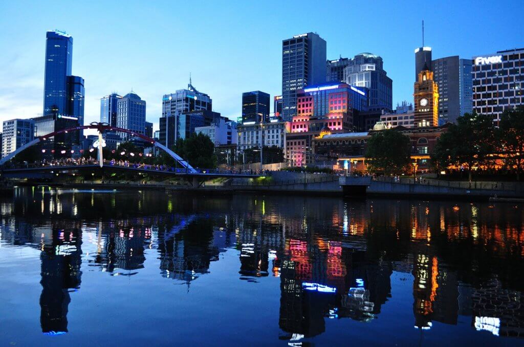 A view of the Melbourne city skyline illuminated at dusk.