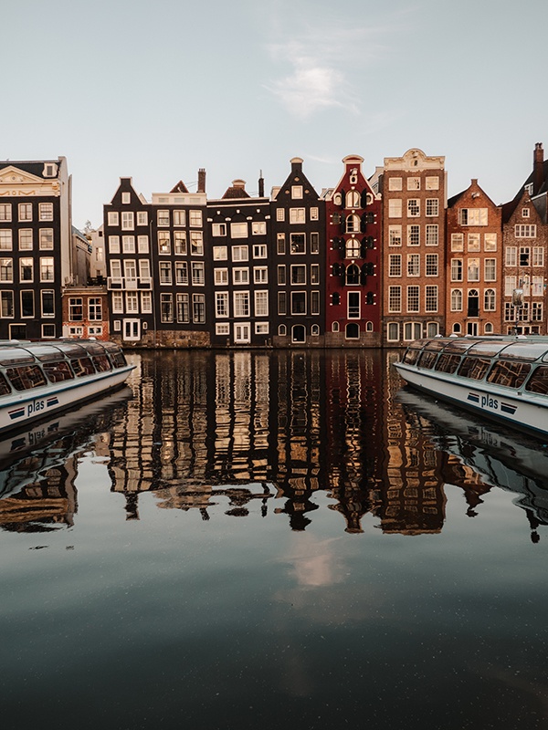 Narrow houses crowded onto the waterfront in Amsterdam.